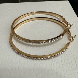 Brand new costume jewelry. Crystal gold hoop earrings.